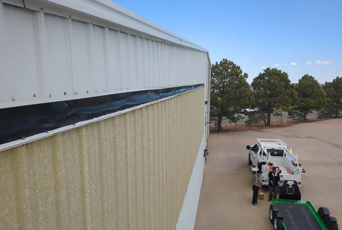 New hangar door top seal installed, full-length exterior view