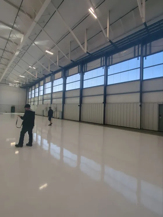 Sliding bottom-rolling hangar door system, wide interior view