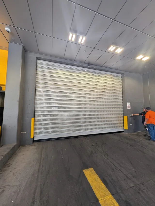 Repaired high-speed door, technician testing the control panel