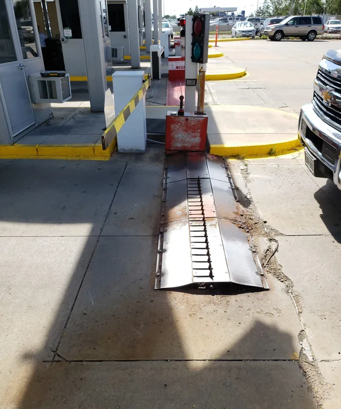 Damaged traffic control barrier and tire spike system