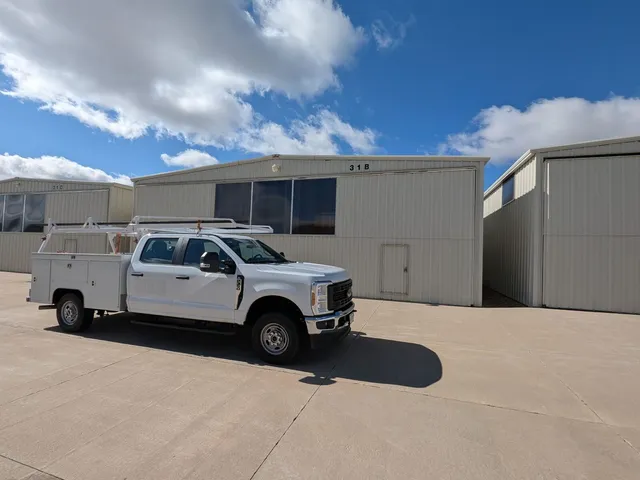 HPDS service truck parked at a hangar facility